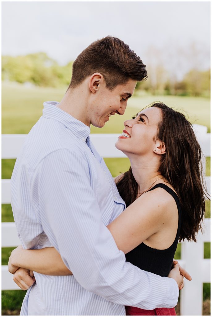 couple pose hugging and looking into each other's eyes