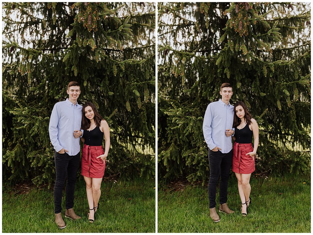 couple pose standing and smiling at the camera
