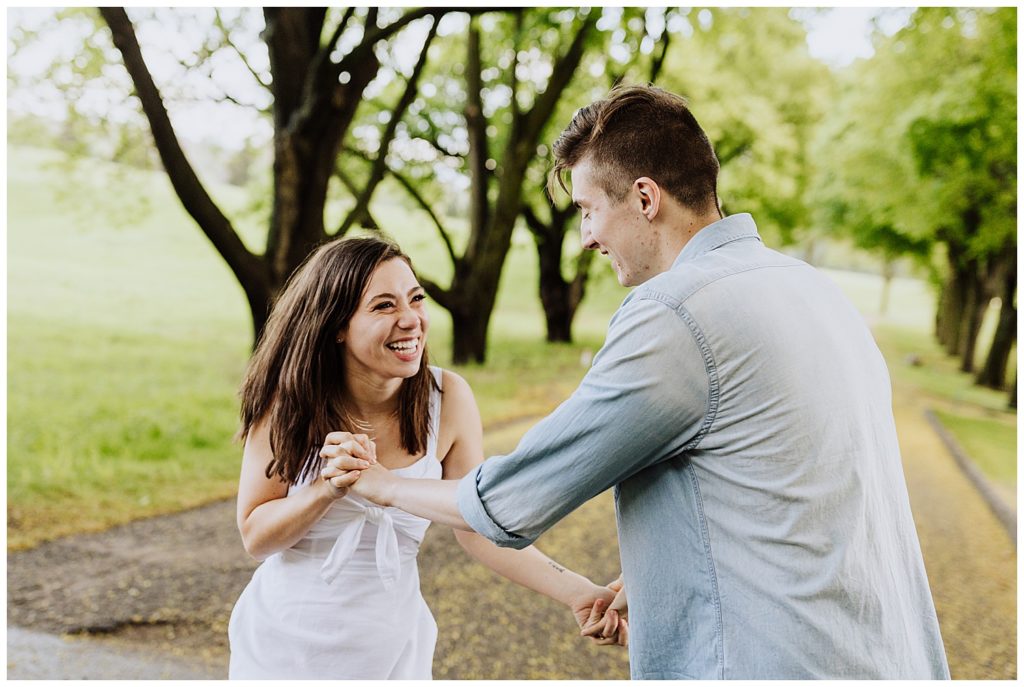 couple pose laughing at each other