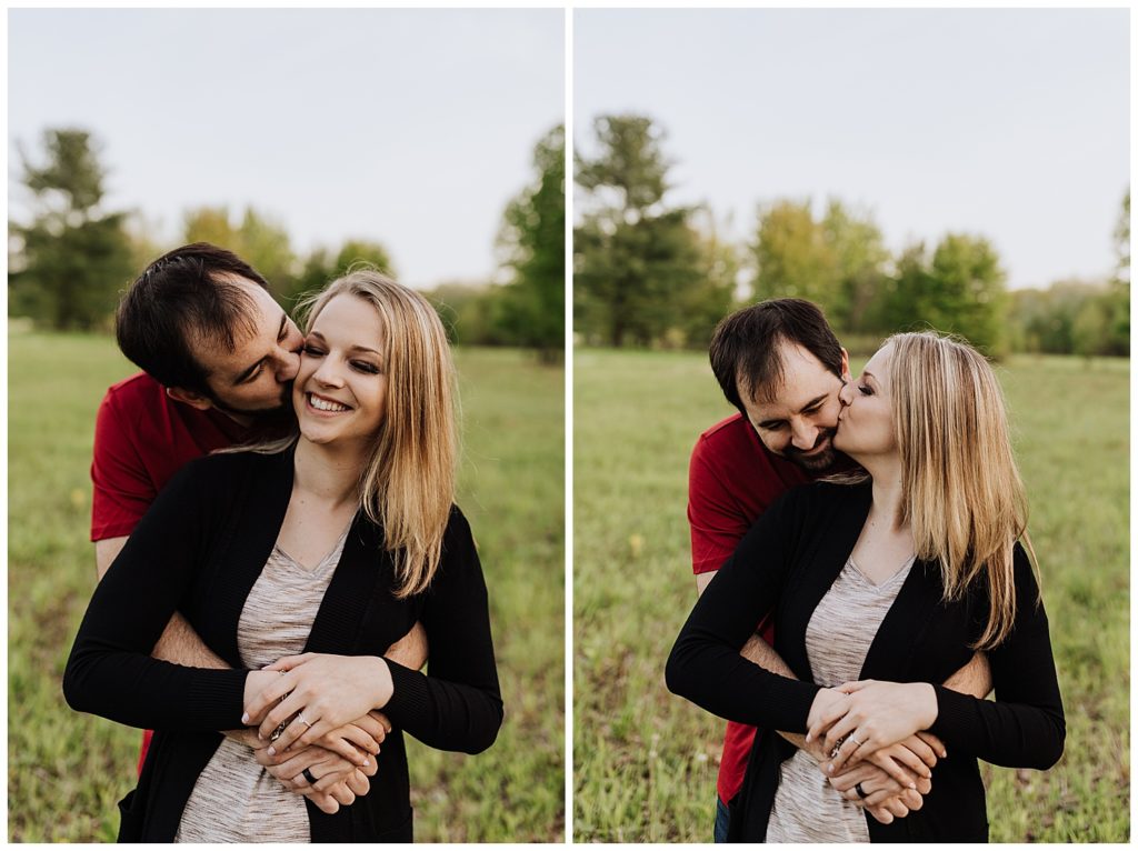 couple pose kissing each others cheek 