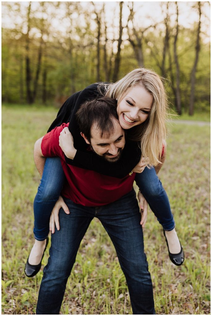 couple pose on his back laughing 