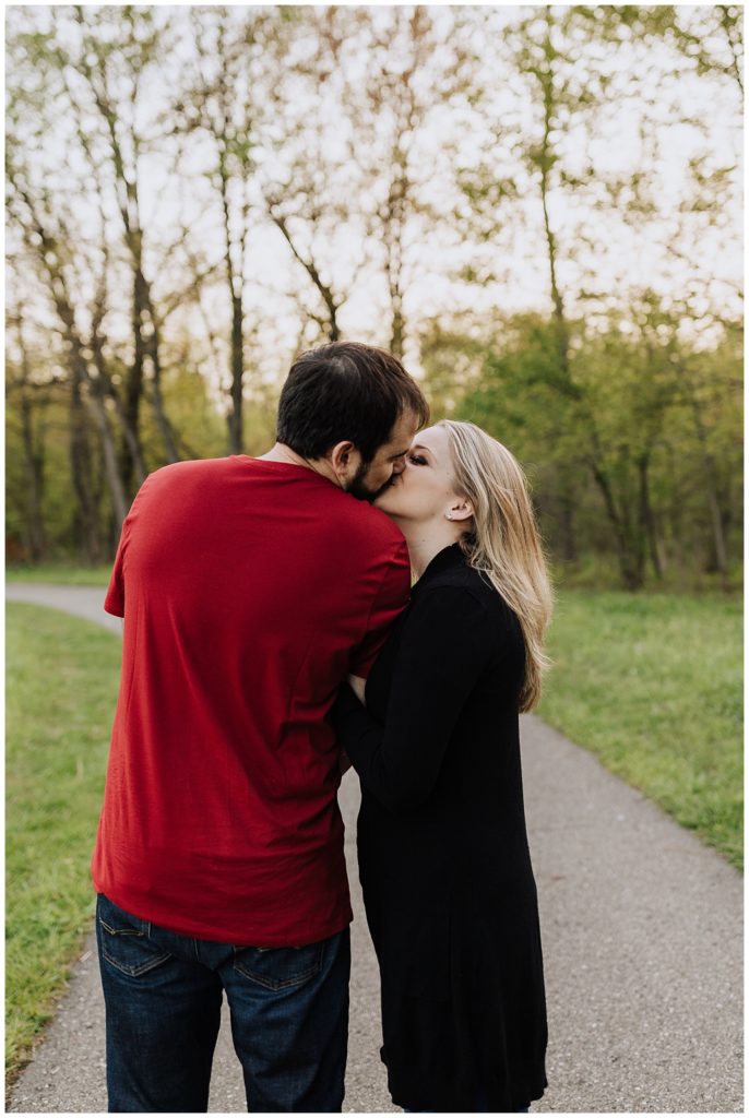 couple pose standing and kissing 