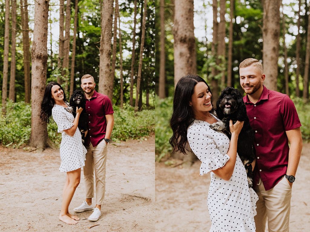 couple smiling at the camera with dog