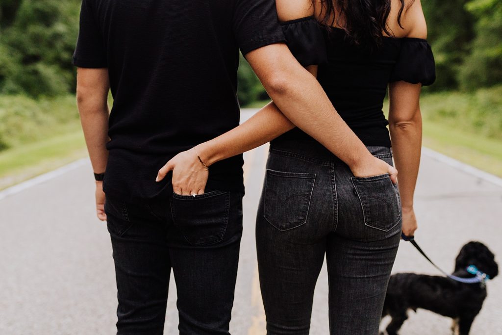 couple's hands in eachother's back pockets