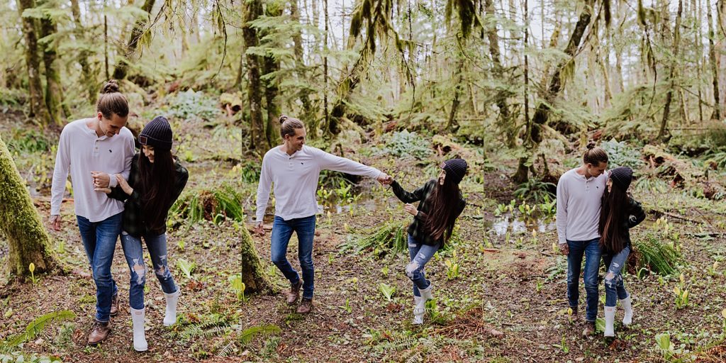 oregon couple walking through the woods holding hands 