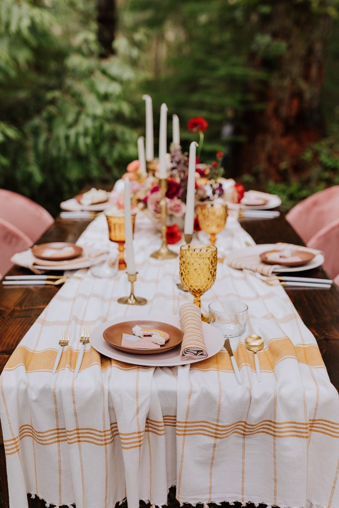 wedding reception table decoration pink flowers rainbows orange table cloth