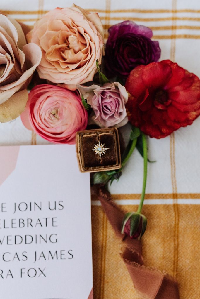 wedding invitation flatlay, flowers, ribbons, yellow tablecloth