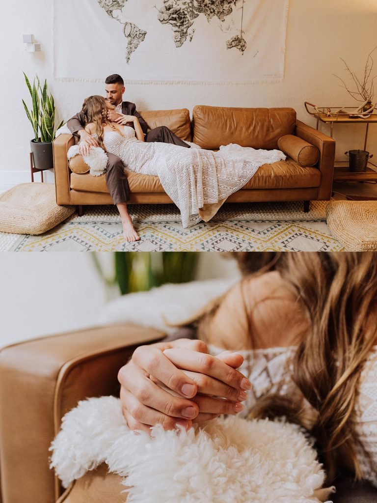bride and groom sitting on leather couch and holding hands