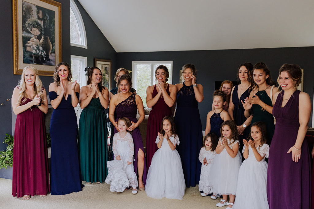bridal party seeing the bride in her dress