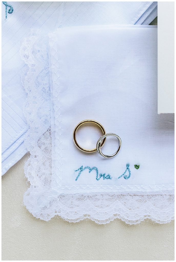 Wedding rings on linen by Kayla Bouren Photography