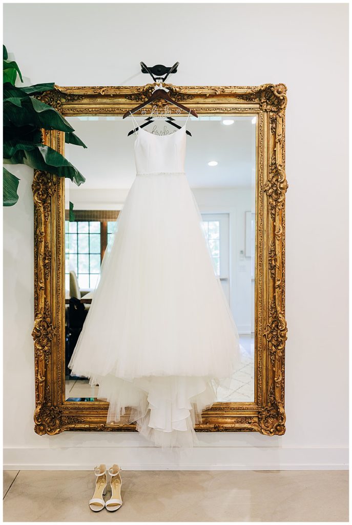 Bridal gown on gold mirror during Cushing Field House wedding
