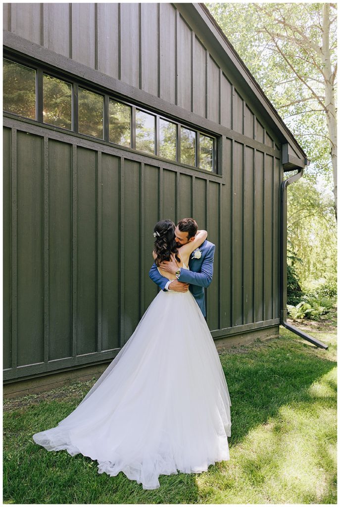 Wedding couple share a bug hug with smiles during Cushing Field House wedding