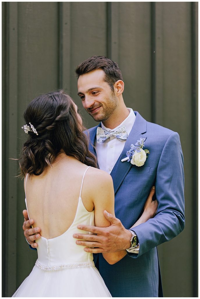 Groom smiles at bride by Detroit Wedding Photographer