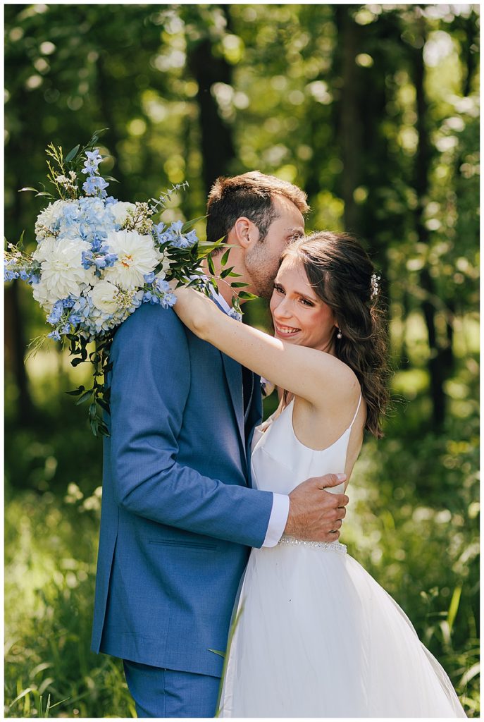 Groom kisses bride by Detroit Wedding Photographer