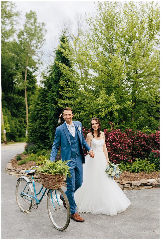 Wedding couple is moving bike by Detroit Wedding Photographer