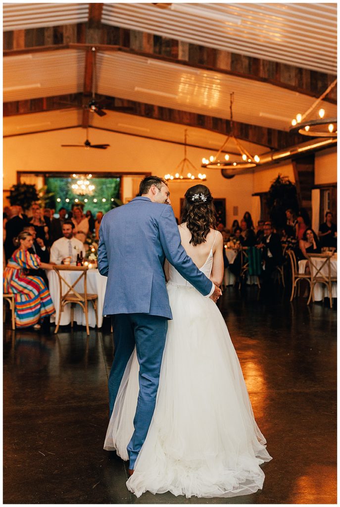 Husband and wife dance during reception at Cushing Field House wedding
