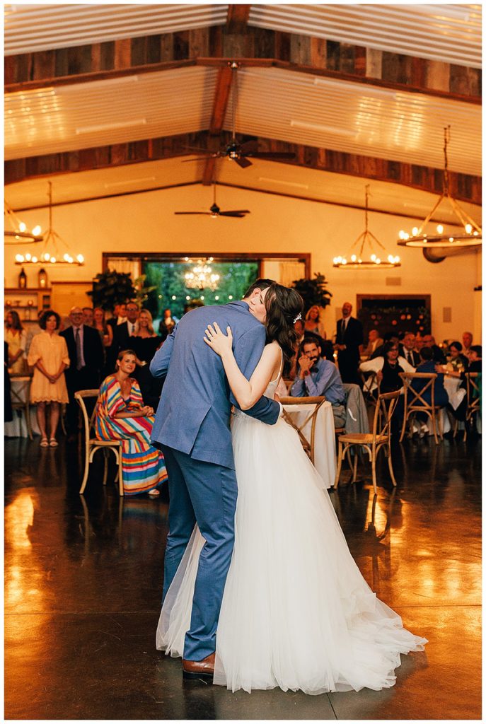 Husband and wife share a hug on dance floor by Detroit Wedding Photographer