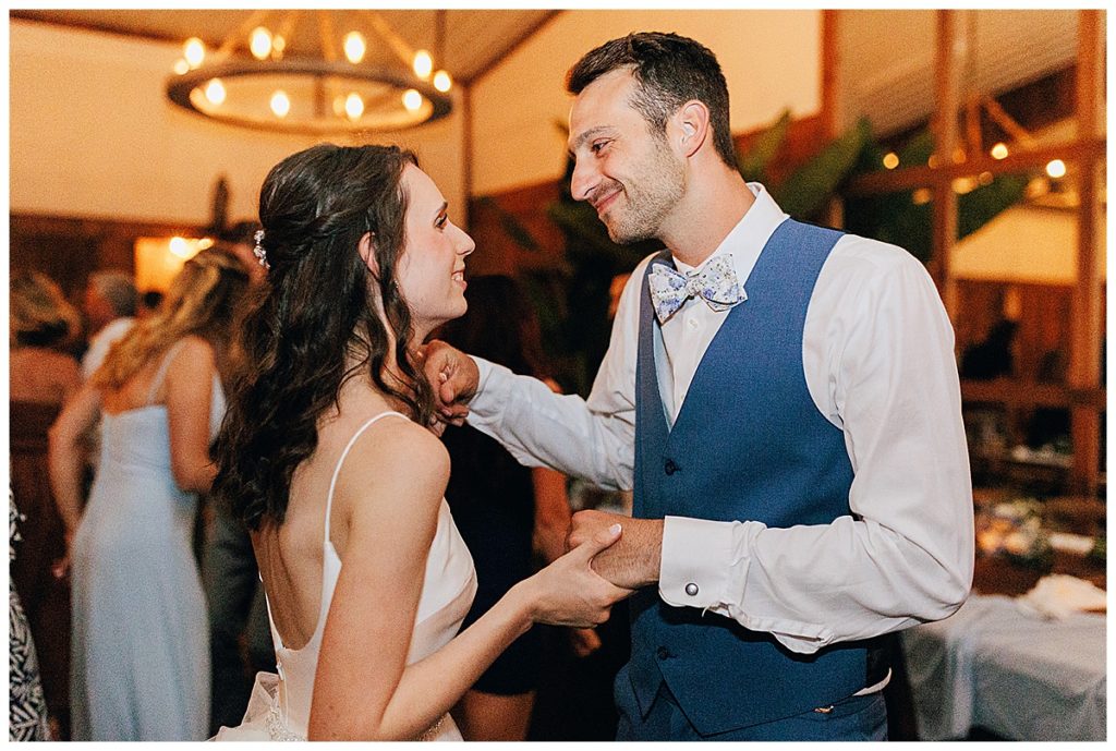Bride and groom dance together by Kayla Bouren Photography