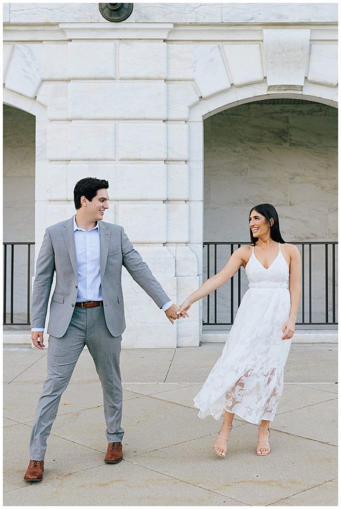 Couple holds hand and smiles during Detroit Institute of the Arts Engagement Session