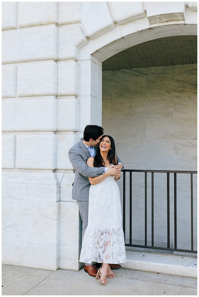 Couple share a smile and kiss for Detroit Institute of the Arts Engagement Session