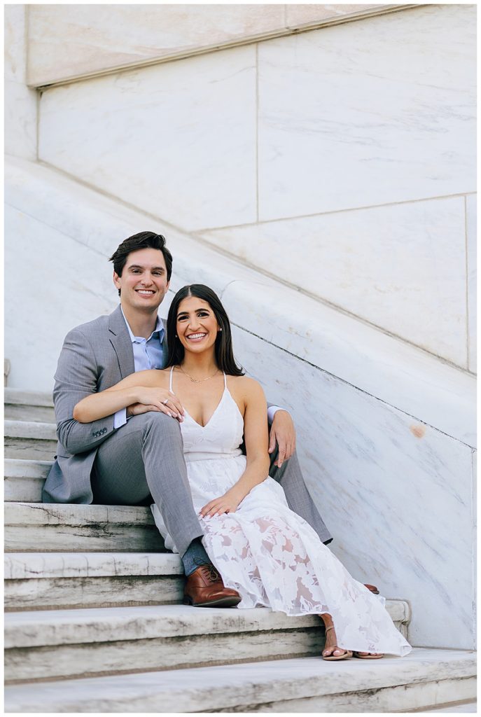 Couple sits on stairs and smiles for Detroit Wedding Photographer
