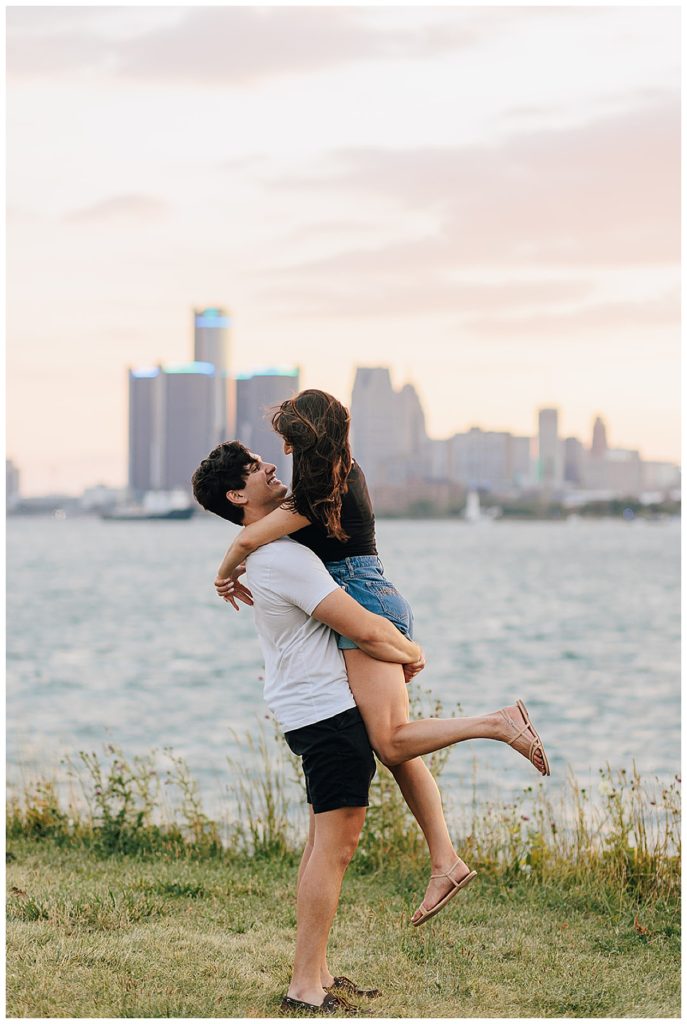 Woman is being picked up on lakefront by Detroit Wedding Photographer