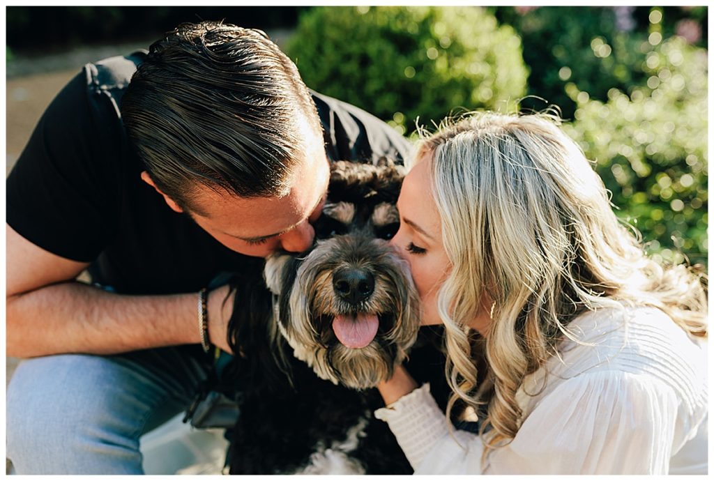 Couple giving dog a kiss by Detroit Wedding Photographer