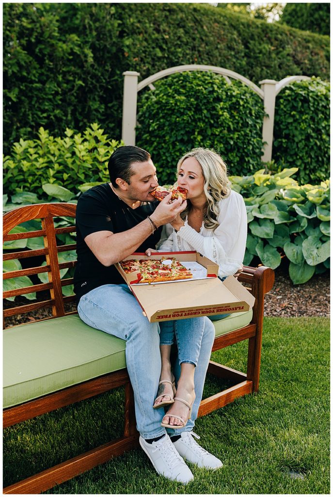 Couple eating pizza on bench by Detroit Wedding Photographer