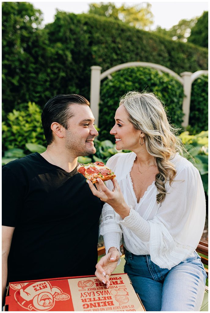 Couple smiling while eating pizza during Grosse Pointe Engagement Session