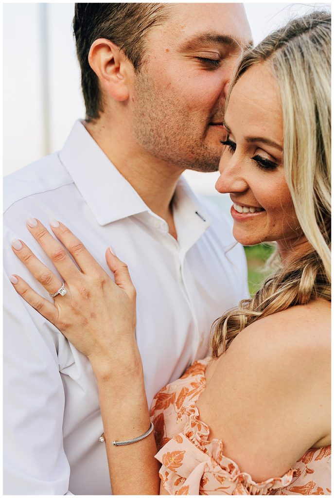 Guy kisses woman on cheek by Detroit Wedding Photographer