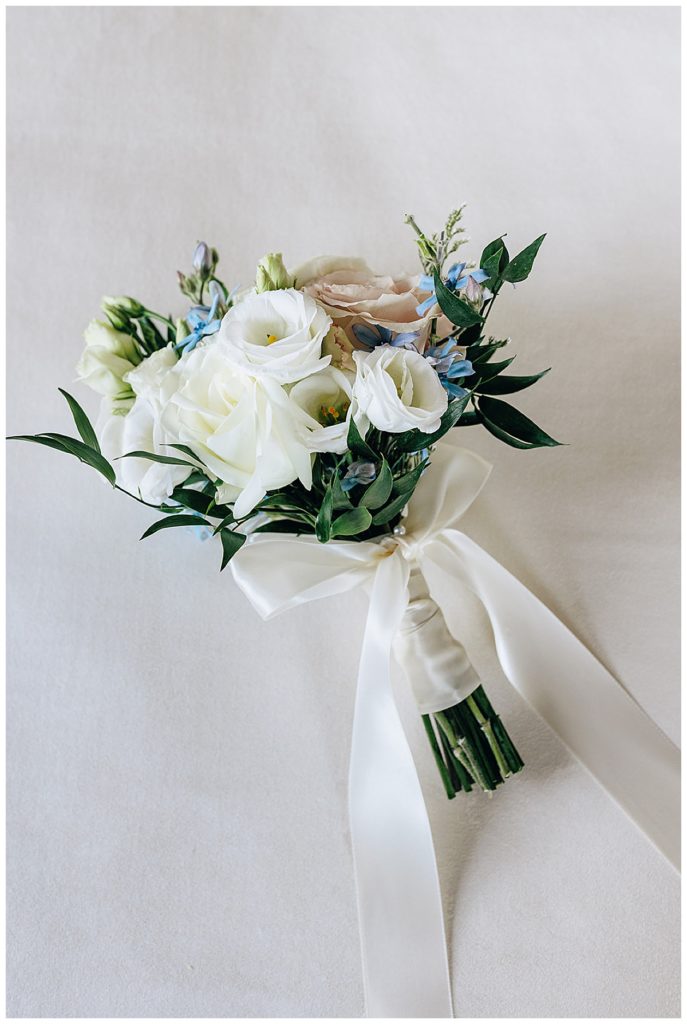 Bridal flowers are wrapped in white linen by Detroit Wedding Photographer.