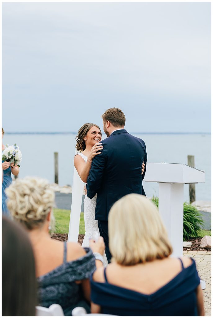Bride holds groom during wedding by Detroit wedding photographer
