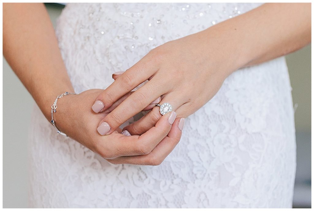 Bride adjusting ring for Detroit wedding photographer