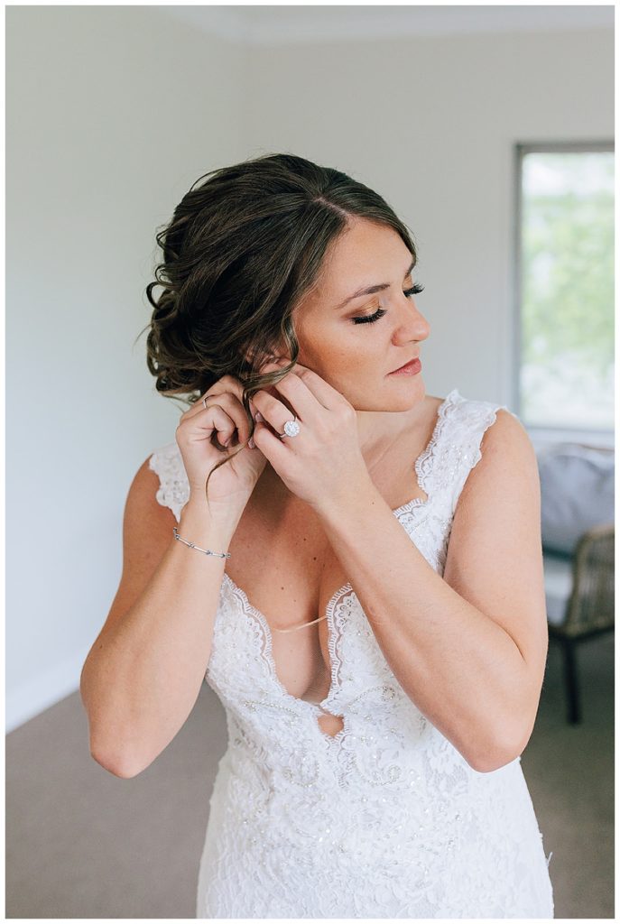 Bride putting on earrings for Lake St. Clair wedding