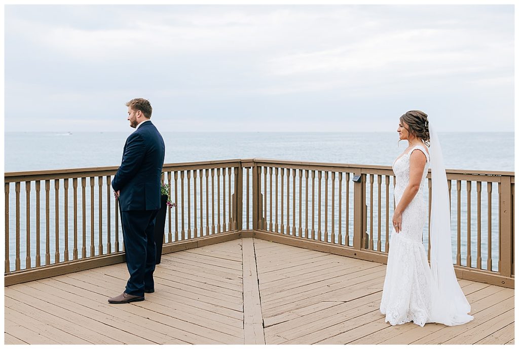 Bride sneaking up to groom for first look by Kayla Bouren Photography.