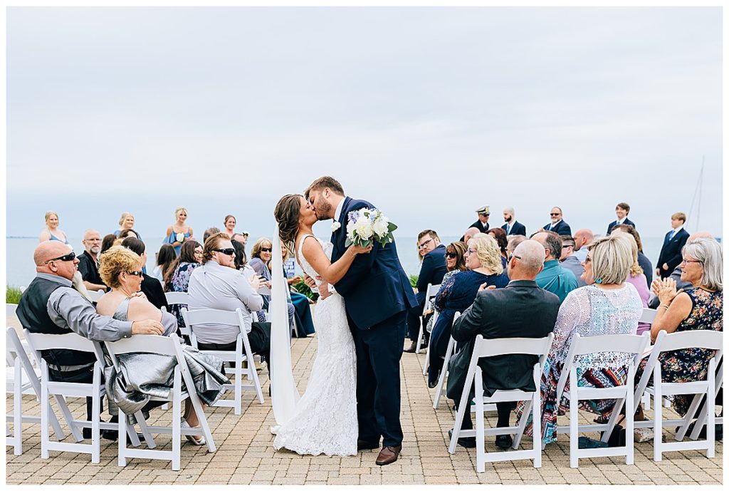 Wife hugs and kisses husband at Lake St.Clair wedding