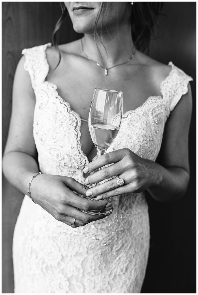 Bride holds bottle of champagne by Kayla Bouren Photography.