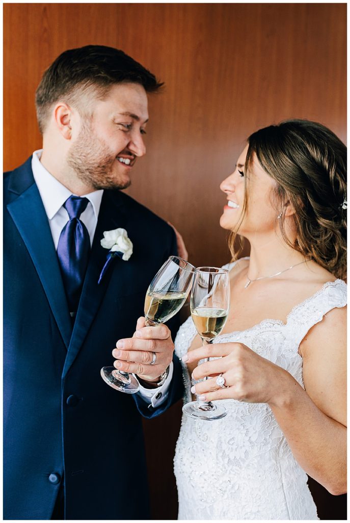 Husband and wife toast and cheers by Detroit wedding photographer