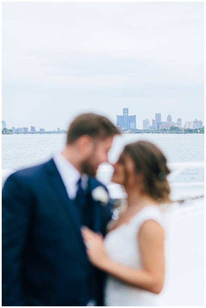 Waterfront downtown view behind bride and groom at Lake St.Clair wedding