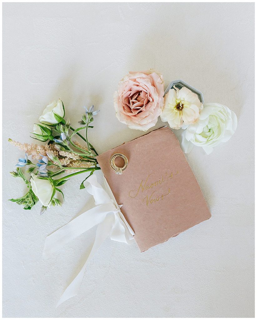 Vow book with flowers by Kayla Bouren Photography