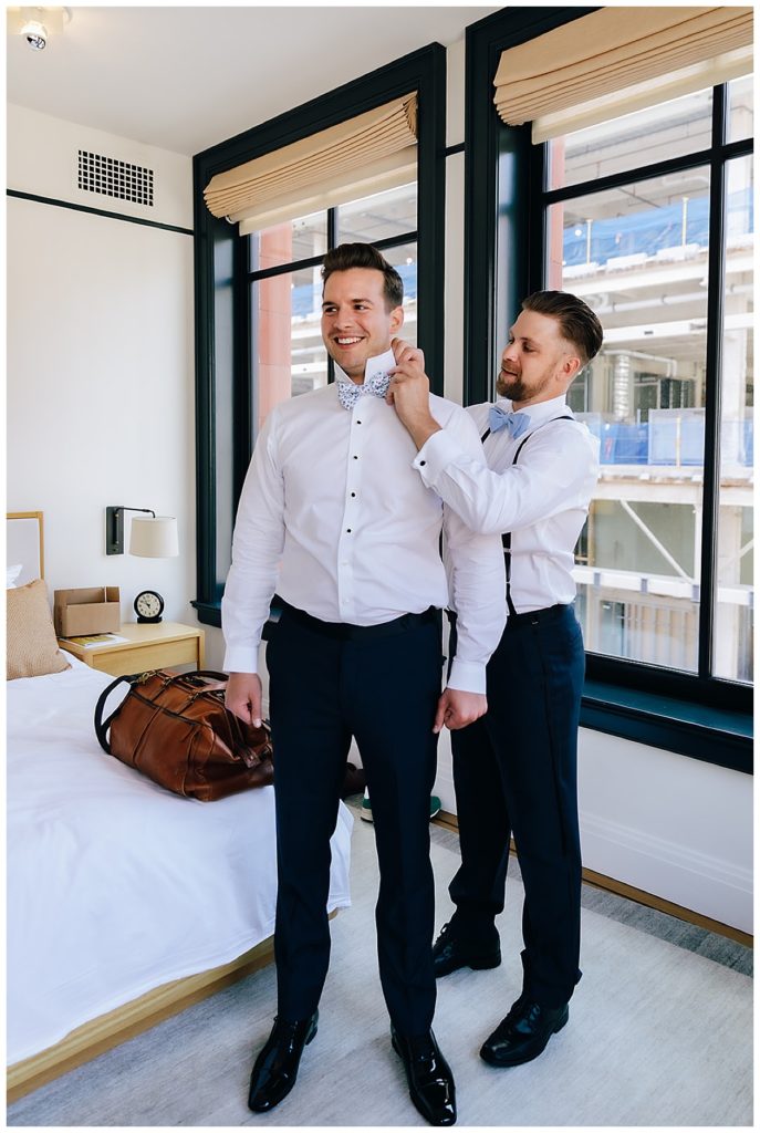 Groom gets ready with help by Kayla Bouren Photography