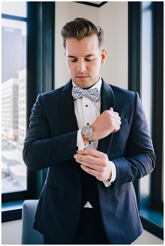 Groom adjusting cufflinks for Michigan Wedding Photographer