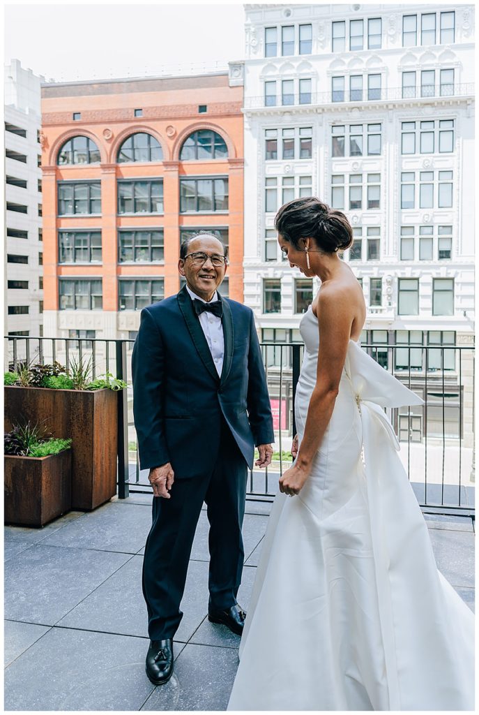 Father of the bride smiles at bride for Chic Detroit Wedding