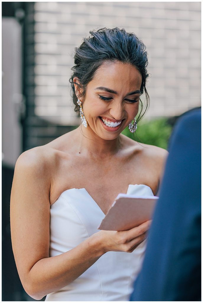 Smiling bride reads personal vows to groom for Michigan Wedding Photographer