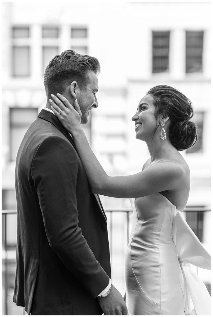 Future husband and wife smile at each other during Chic Detroit Wedding