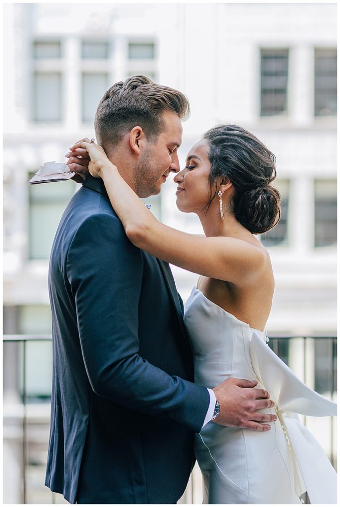 Man pulls woman in close by Michigan Wedding Photographer