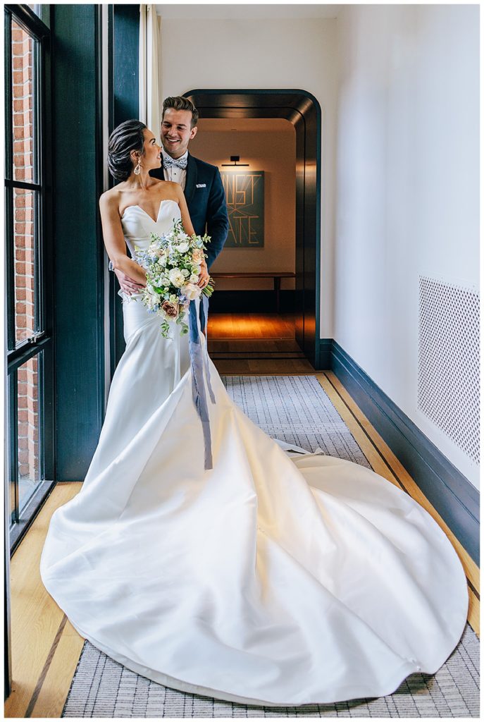 Bride stares and smiles back at groom for Michigan Wedding Photographer