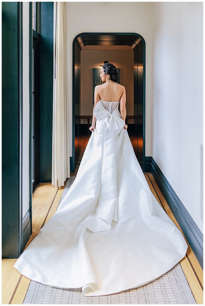 Bride walks down hallway by Michigan Wedding Photographer