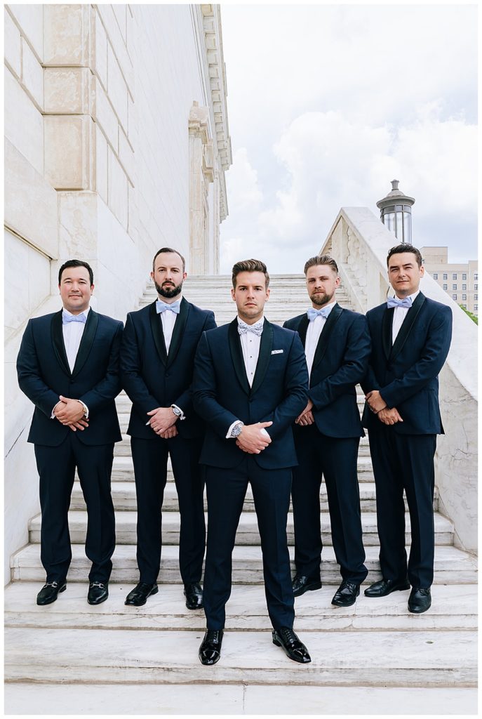 Groom surrounded by wedding attendants for Michigan Wedding Photographer