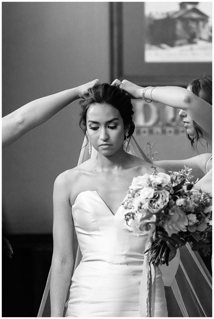 Bride getting veil adjusted for Chic Detroit Wedding